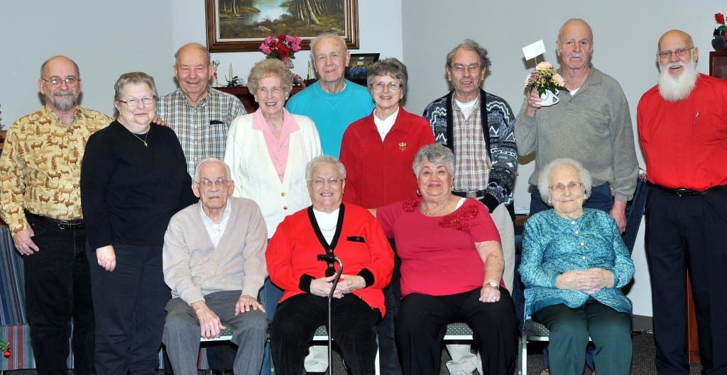 SPECIAL DAY … Celebrating birthdays and anniversaries at Montpelier Senior Center on Thursday, February 14, 2013 were, seated from left, Robert Teats (90th birthday); Carol Custer, Barb Kreischer, Edna Cluckey (98th birthday) and, standing from left, Charles and Sandra Cluckey (36th Wedding Anniversary), Richard Barnhart, Marge and Dane Michael (64th Wedding Anniversary), Jane Rath, Larry Wells, Doyle Smethurst, Jim Lehman. Hosting this month’s Birthday celebration were T.R.U.S.T. students from Bryan High School.  Site Manager Jewel Head was also pleased to announce Doyle Smethurst (floral arrangement from Huntington Bank tellers) and Sandra Cluckey (two free Senior Center Lunches) as February’s Monthly Door Prize winners.