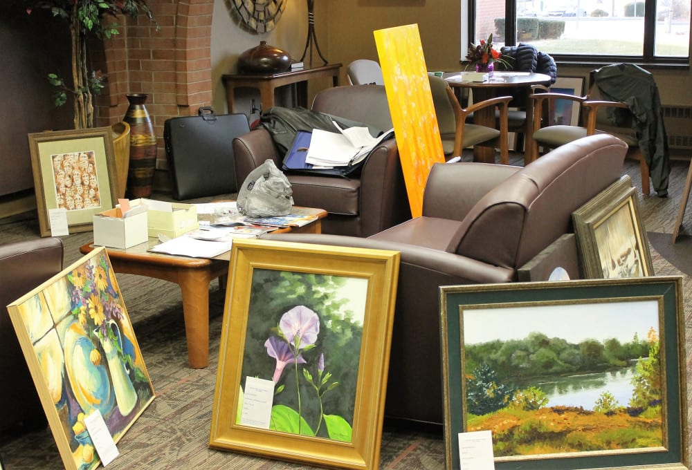 Some of the almost 100 pieces sit prepped and ready to be hung in their new homes.