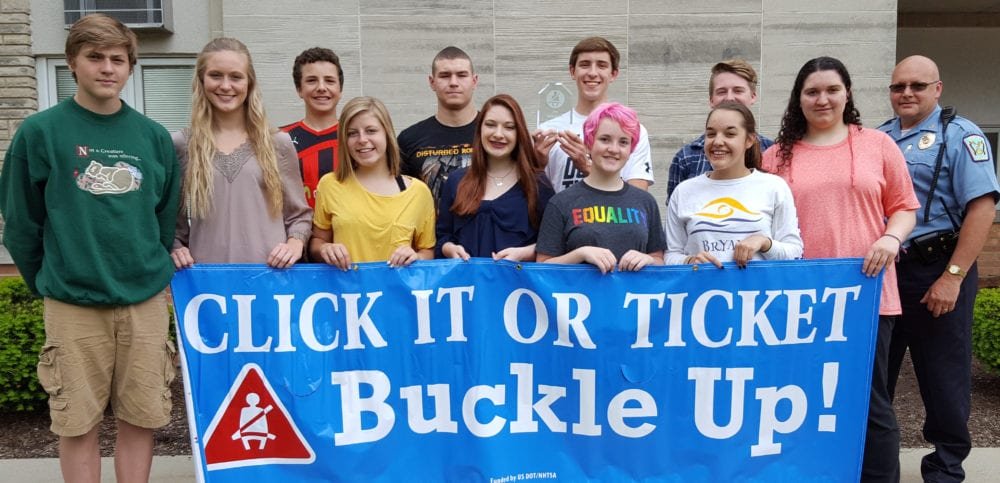 Bryan HS 2016 WEB - The Village Reporter “Most Improved Seat Belt Usage Percentage” from 64.8 % to 82.4%. Pictured Left to Right. Front Row: Seth Pester, McKenna Grube, Sloane Brown, Bayli Sanders, Carolyn Rychener, Lizzy Canfield, Kassidi Martin. Back Row: Isaac Bower, Damon Beltz, Colt Arthur (holding Award), Austin Harding, Chief Michael Willis, Bryan Police Department.