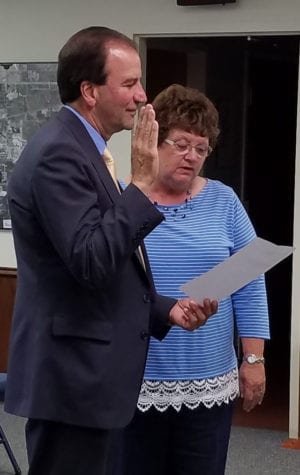 SVC5 WEB - The Village Reporter Kathy Kreuz is sworn in by Law Director Alan Lehenbauer to fill vacant council seat.
