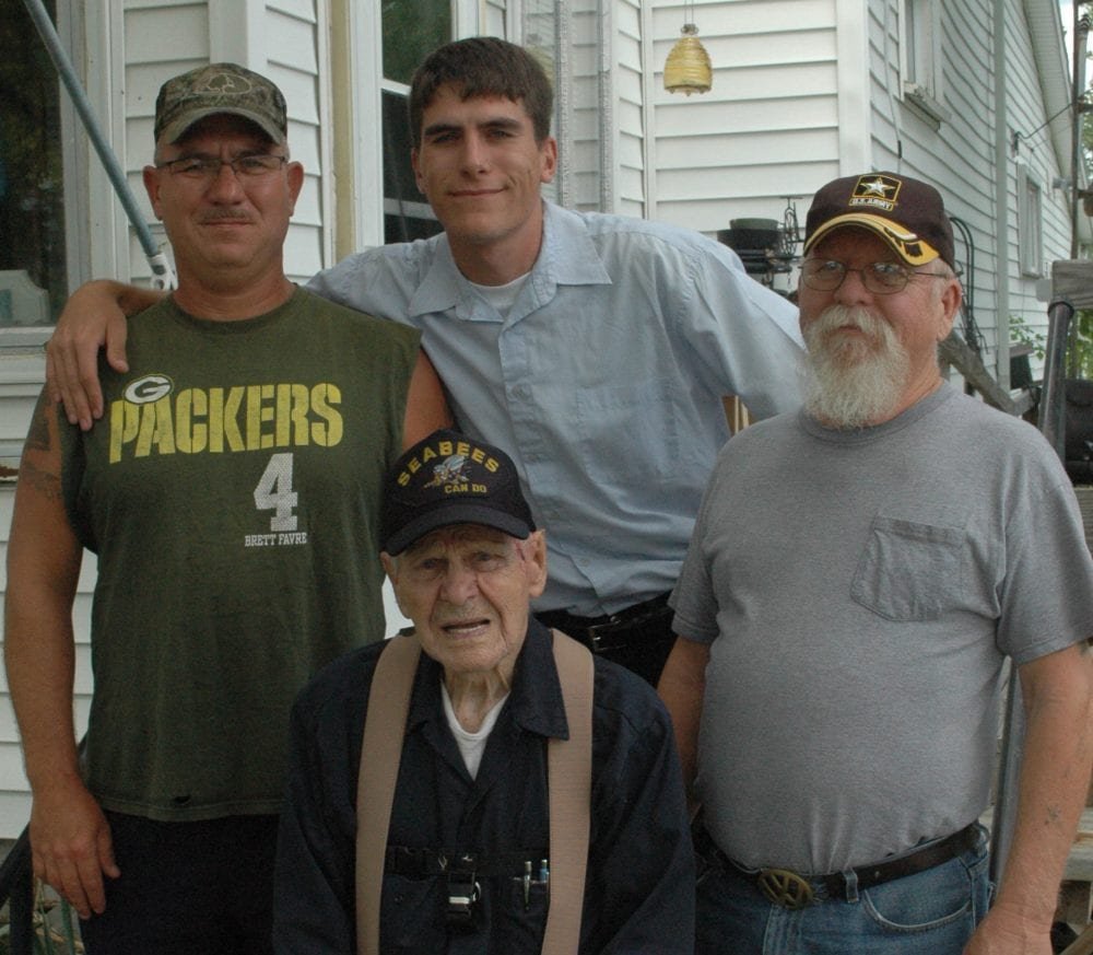 Rummel family 1 WEB - The Village Reporter Ross Rummel was joined for the interview with his son, Raymond Rummel, a nine-year Army veteran; grandson Alan Bumpus, a 15-year Army veteran and great-grandson Michael Bumpus, a four-year veteran of the Marines, both of Hillsdale, Mich.