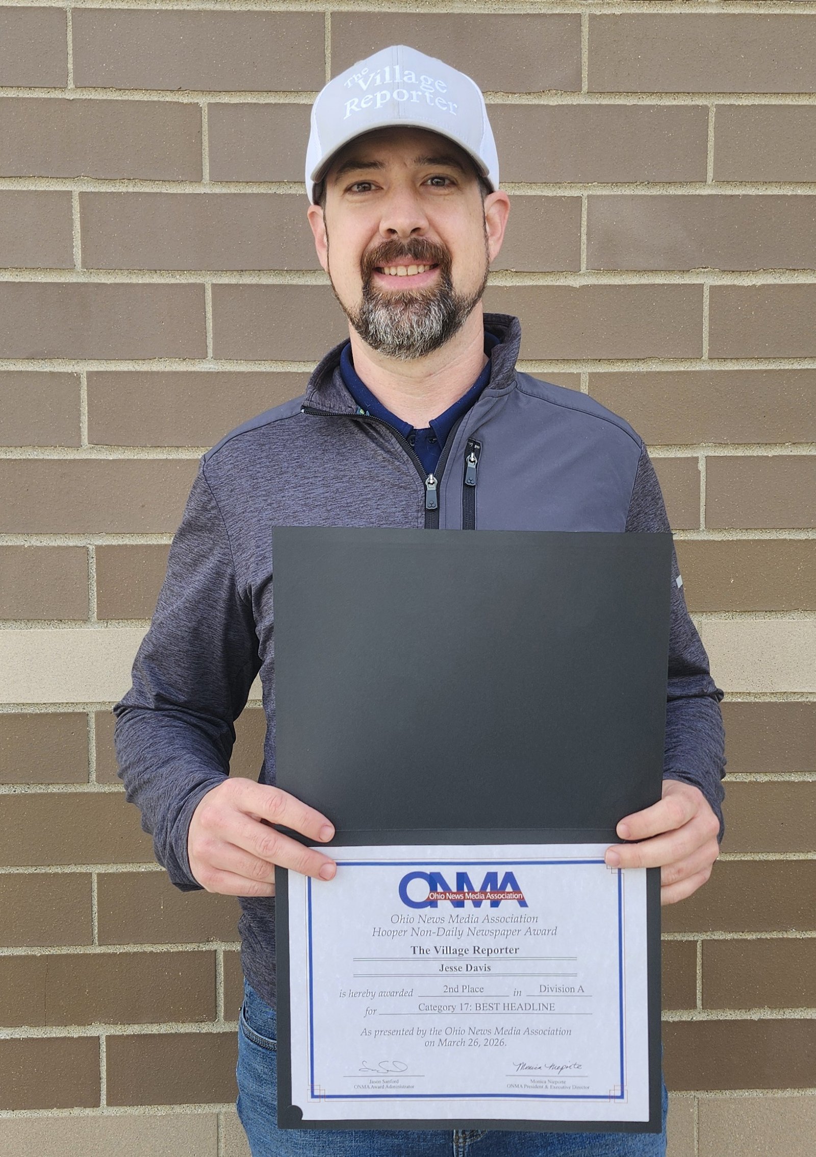 Jesse Davis displays his ONMA certificate