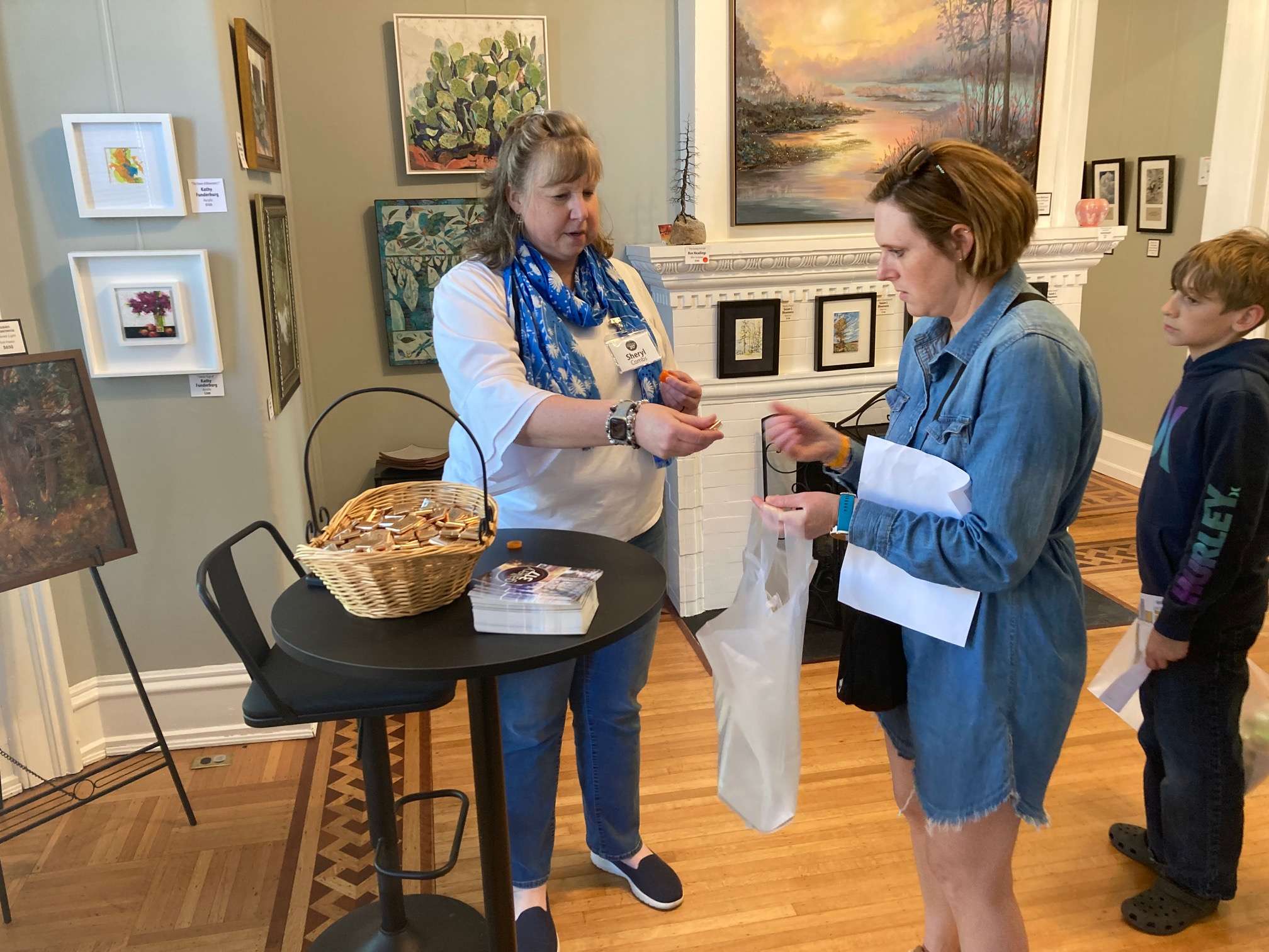 Sheryl Combs, co-owner of Gallery 317, hands out a chocolate sample during the Bryan Development Chocolate Walk.