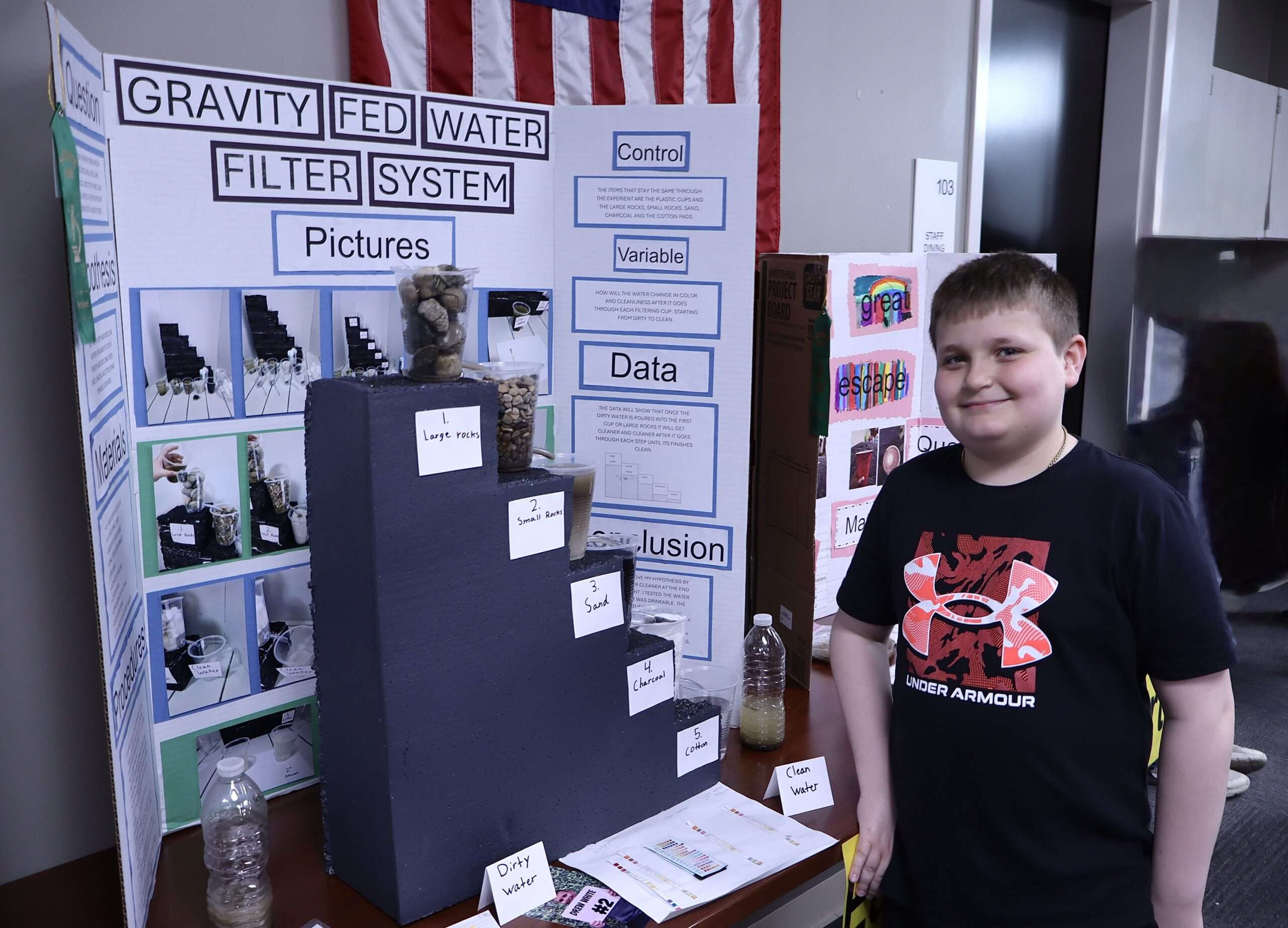 Drew White showed a live water purification system built with rocks, sand, charcoal, and cotton that created safe, clean drinking water.