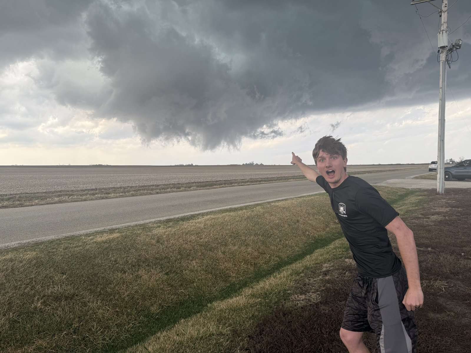 Bryce Reeves stands in front of a wall cloud during the March 10, 2026 storm chase in Illinois