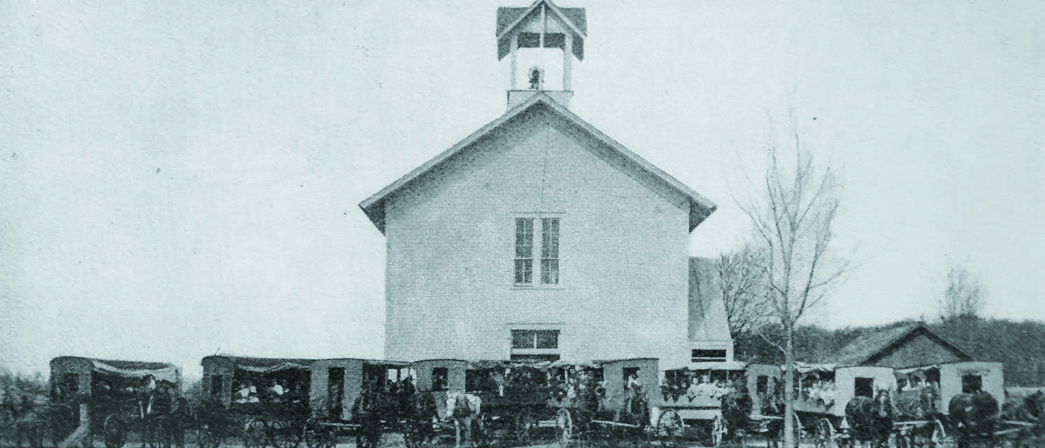 Fulton Township Public School, circa 1909, shown with horse-drawn wagons and students gathered in front.