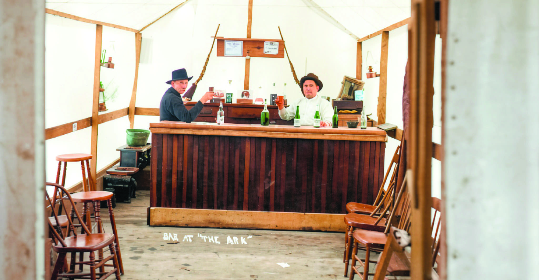 Colorized 1909 image of the bar aboard The Ark, the floating tavern launched from Edgerton on the St. Joseph River.