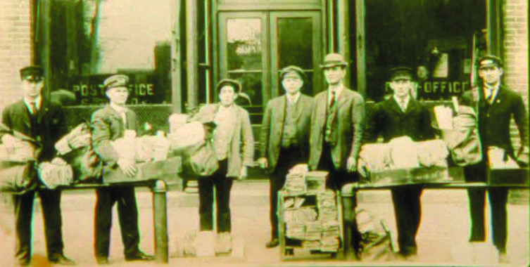 The Swanton Post Office on the west side of North Main Street, early 1900s, with Postmaster Orrin Curtis and staff