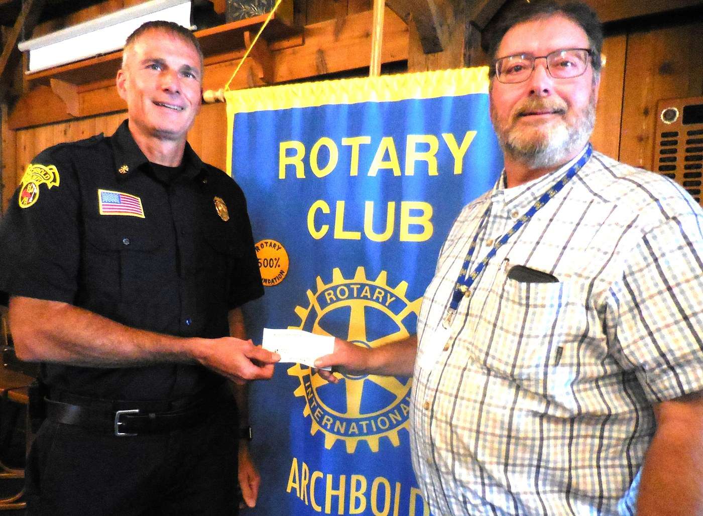 Archbold Rotary President Tod Hug presents Archbold Fire Chief Kyle Brodbeck a $5,000 check