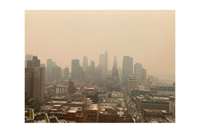 Wildfire smoke haze over city skyline