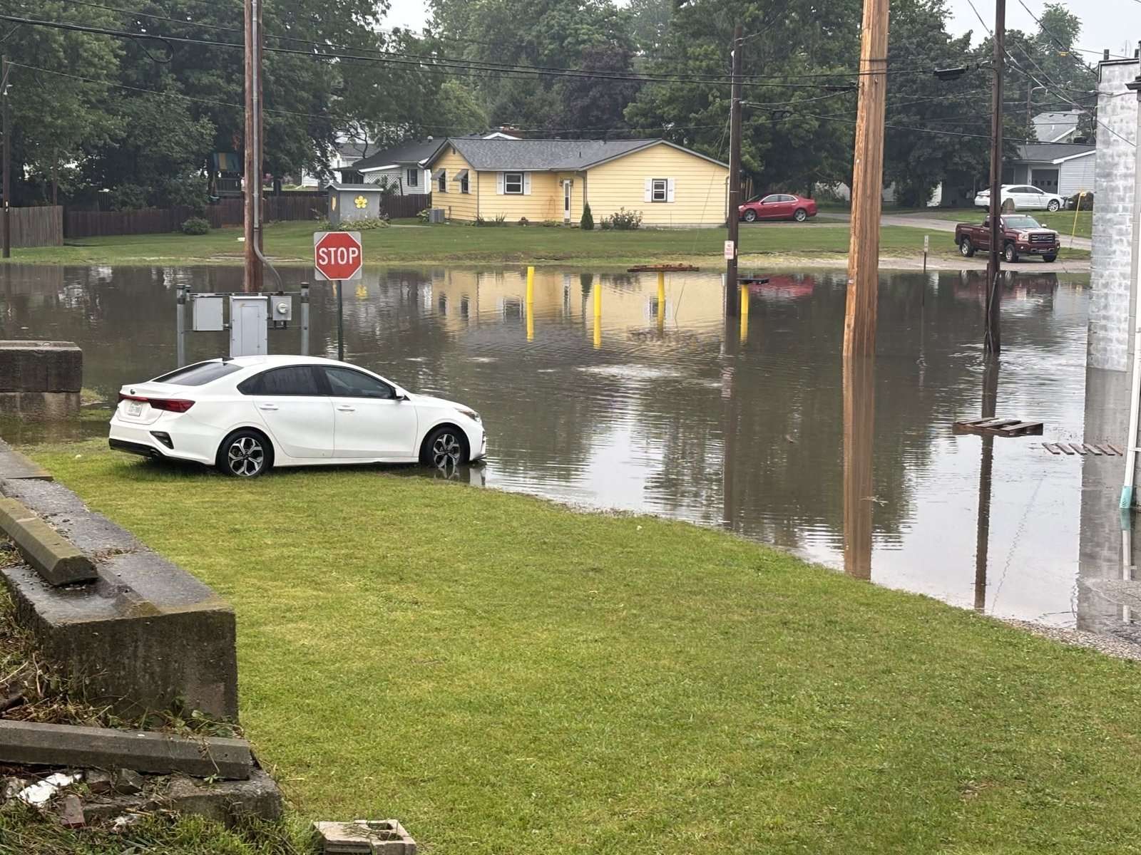 A car sits beside a flooded street in the Montpelier area after heavy rain, July 17, 2026.