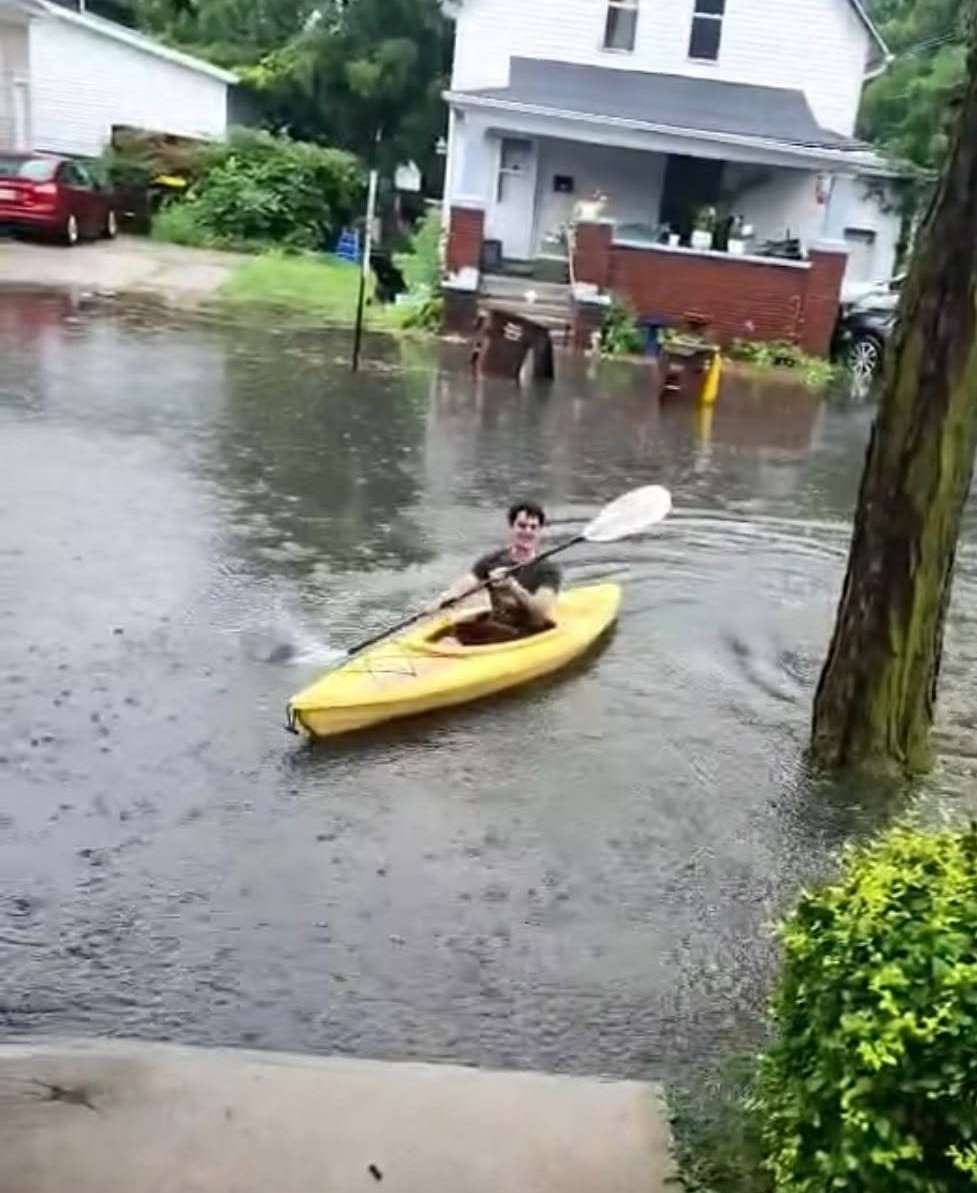 A kayaker paddles down a flooded residential street in the Montpelier area after heavy rain, July 17, 2026.