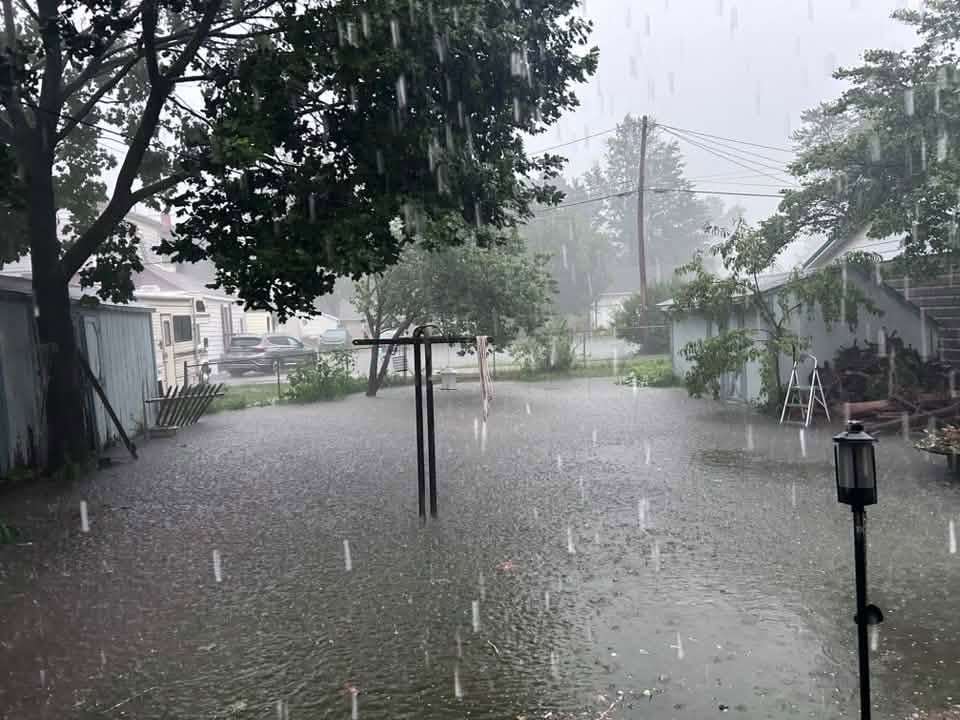 Heavy rain falls over a flooded yard in the Montpelier area, July 17, 2026.