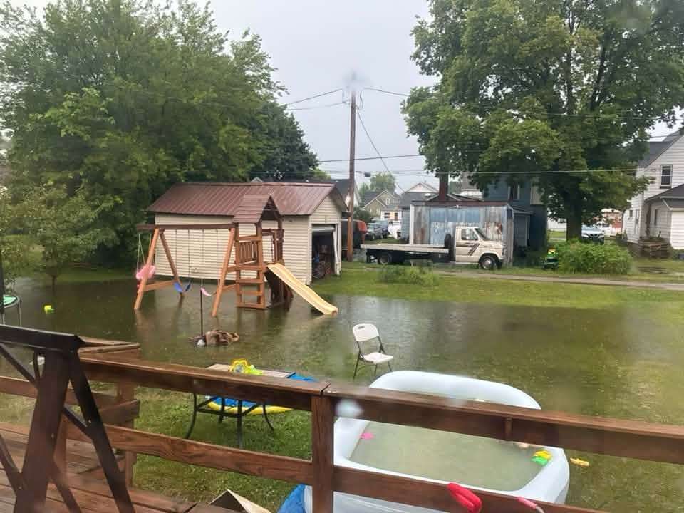 Floodwater surrounds a backyard playset in the Montpelier area, July 17, 2026.