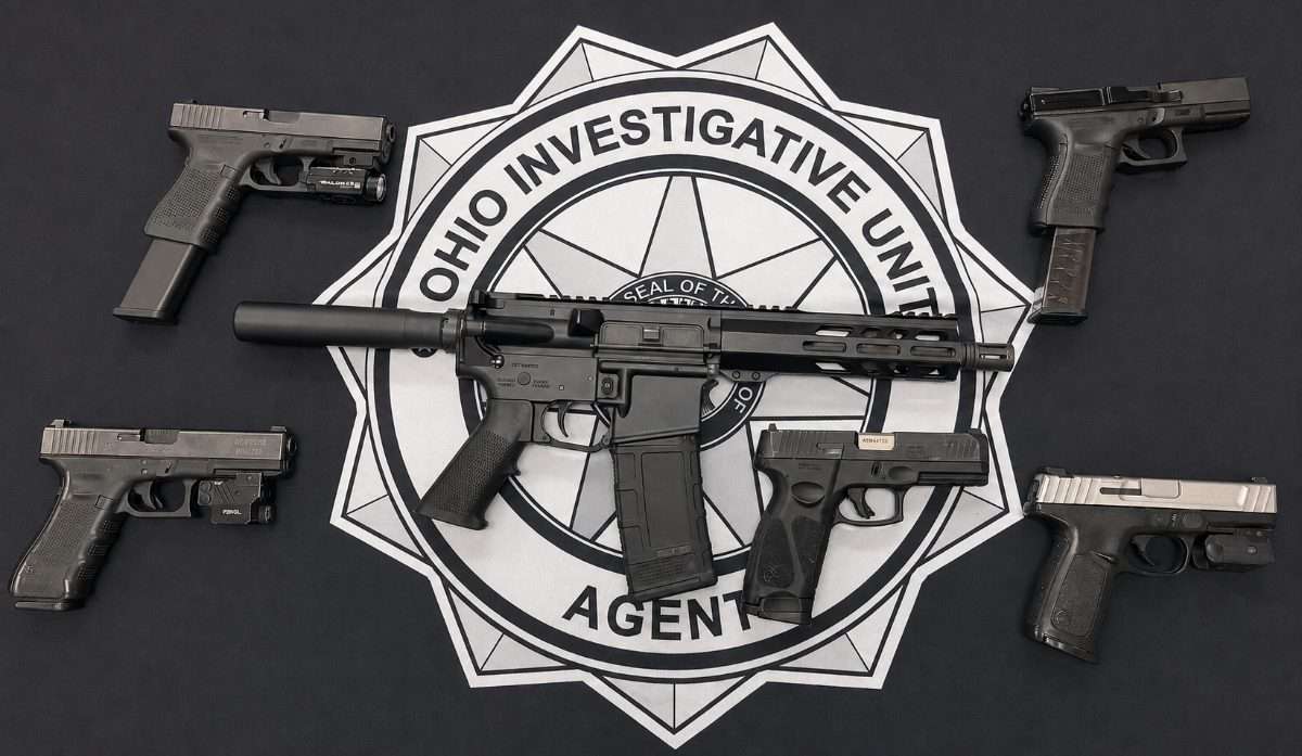 Six firearms recovered by Ohio Investigative Unit agents, displayed on the OIU seal