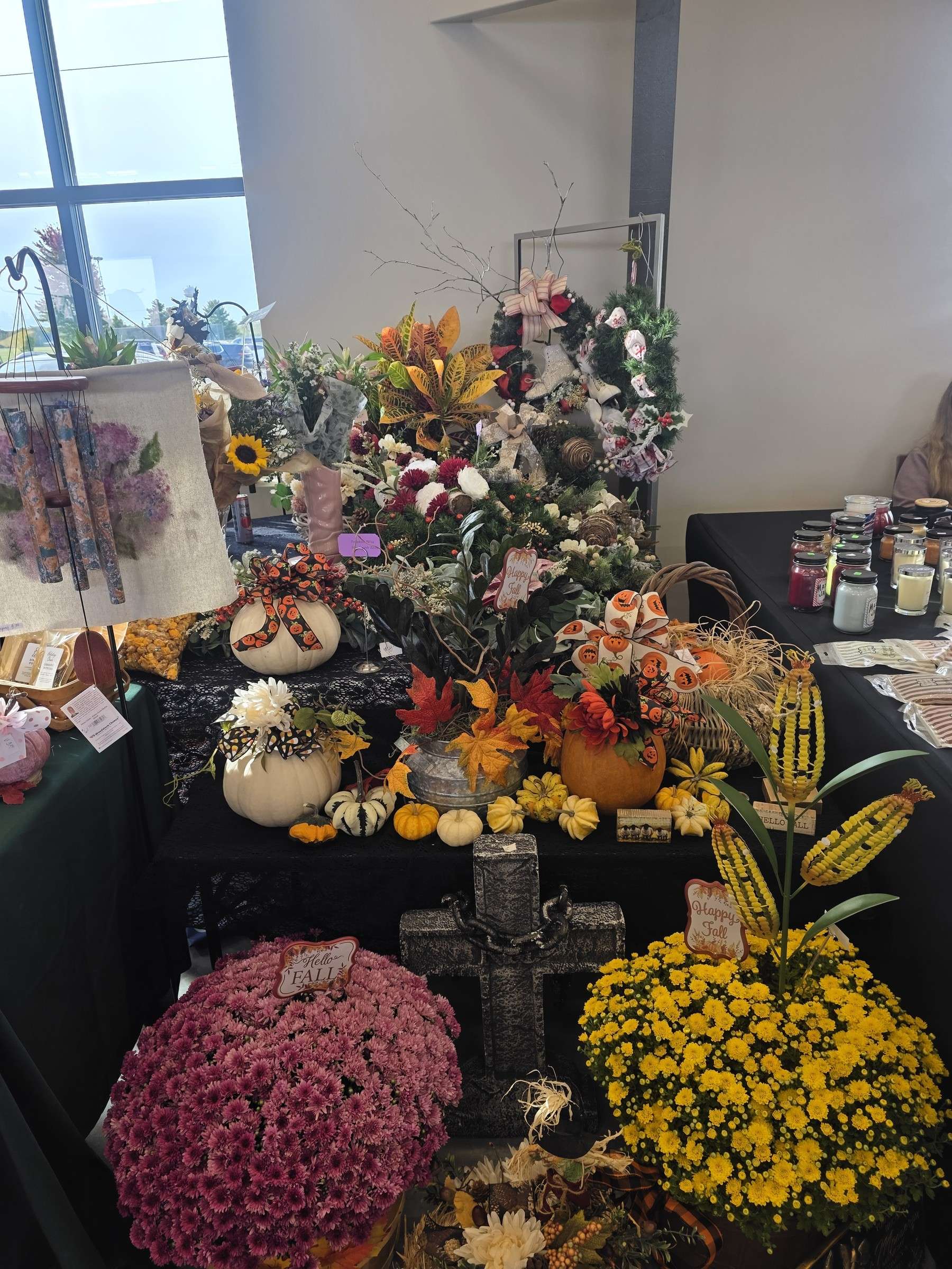 A flower wreath on display at a vendor booth