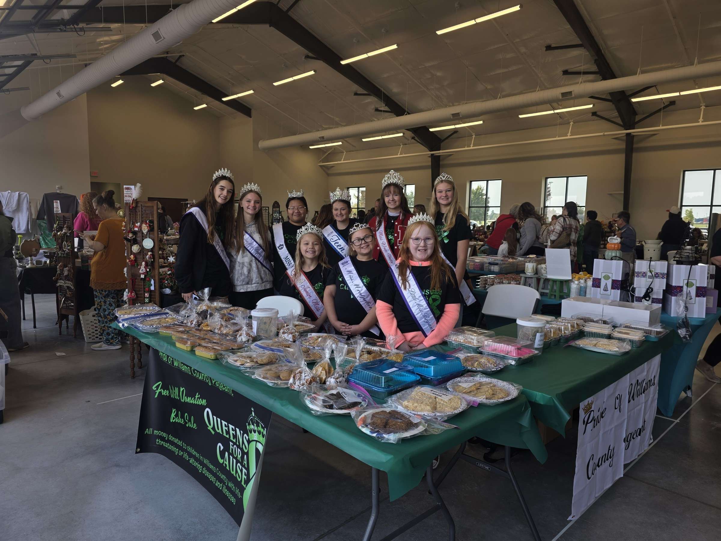 Members of the Pride of Williams County Pageant behind their bake-sale table