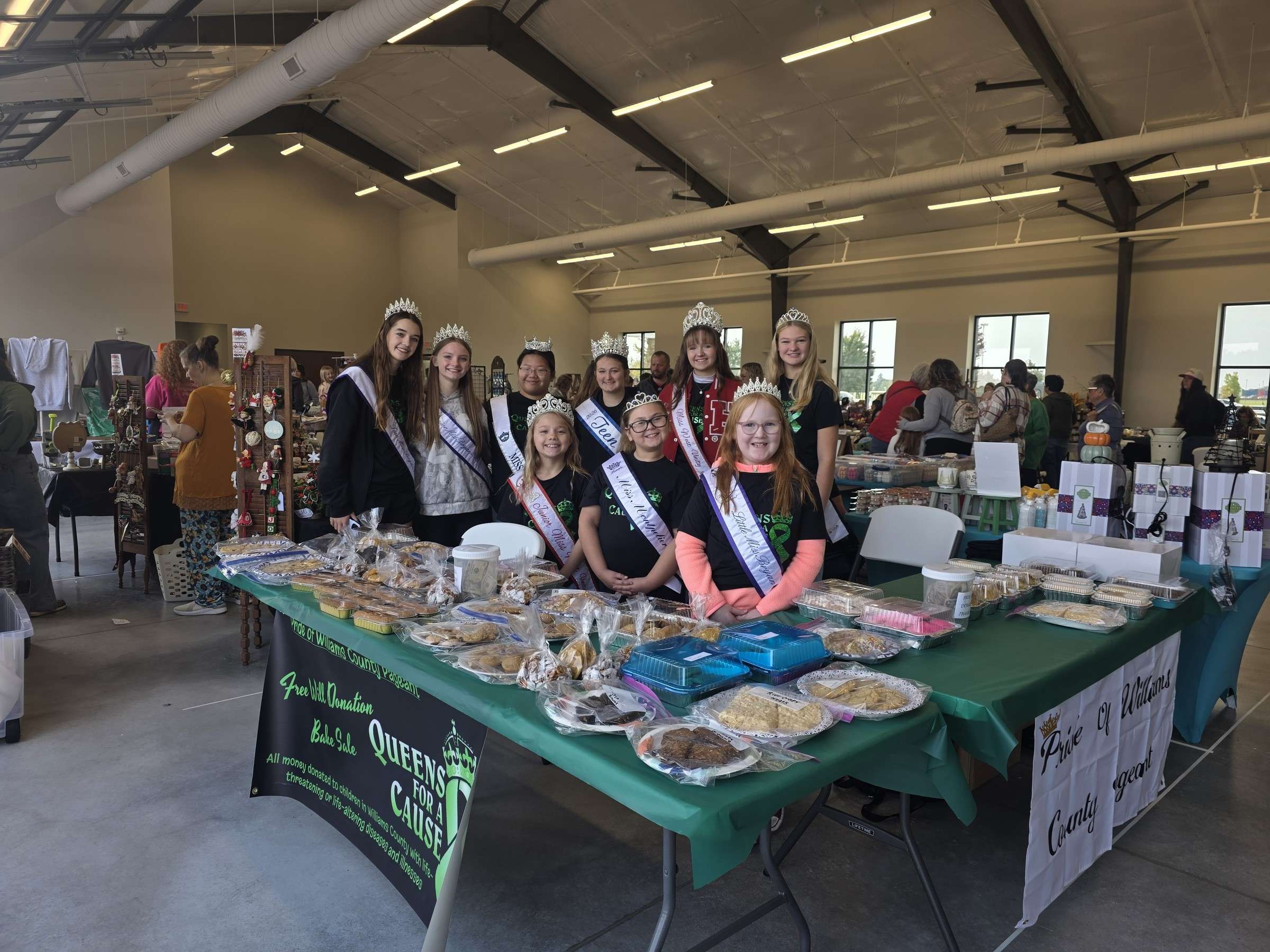 Pageant members and the bake-sale table