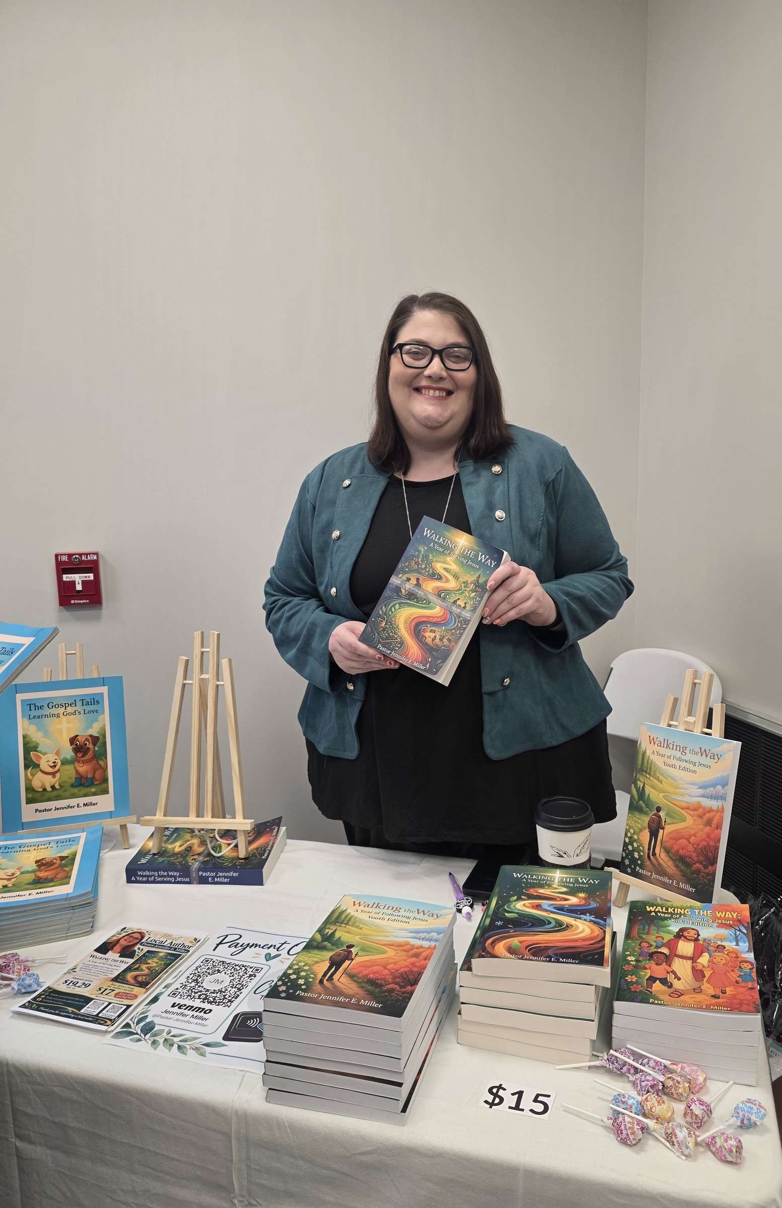 Pastor Jennifer E. Miller with her books at her booth