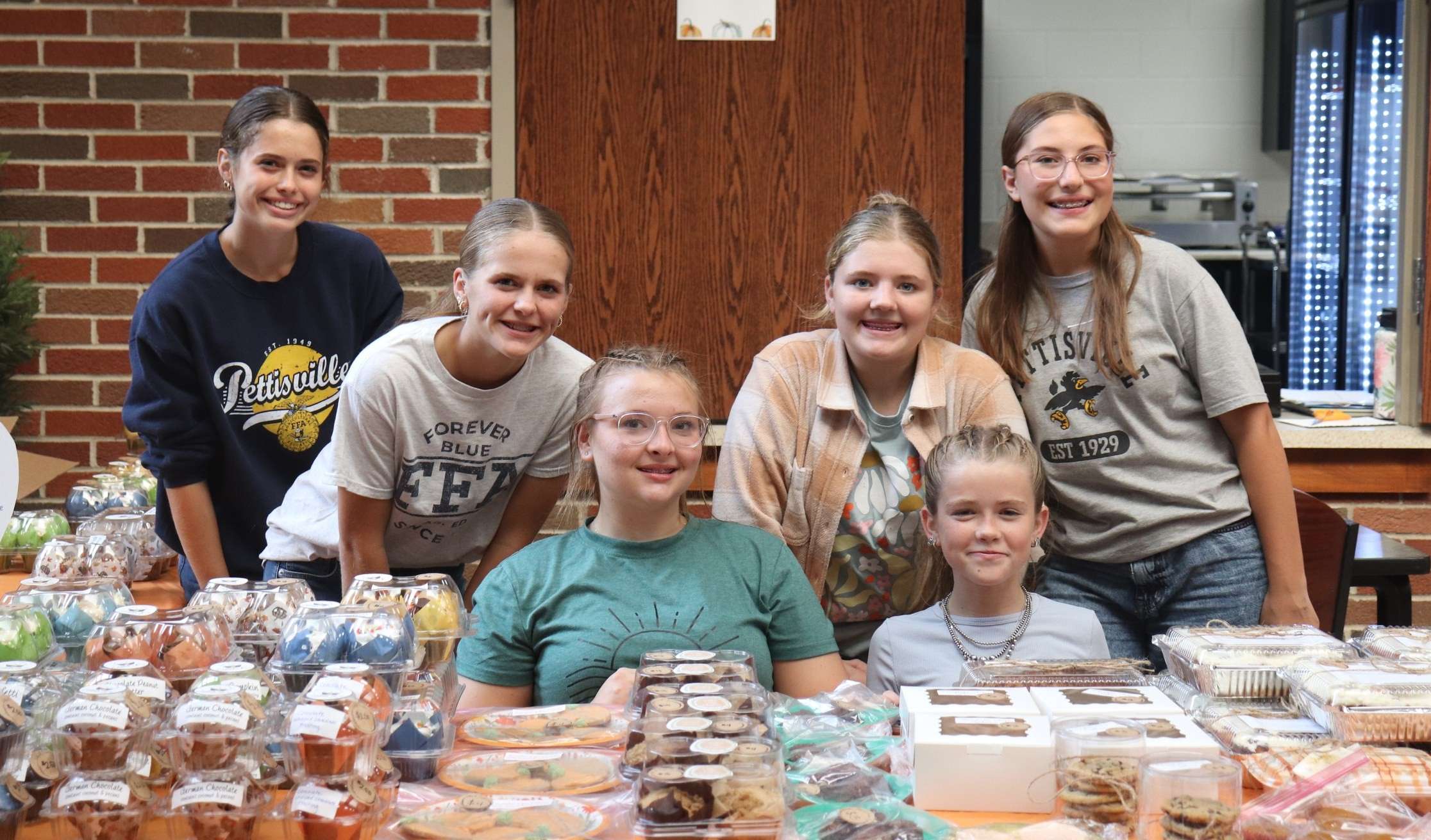 Six FFA members behind the Pumpkin Fest bake sale table