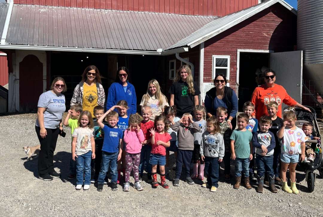 Stryker Preschool afternoon class and teachers in front of a red barn