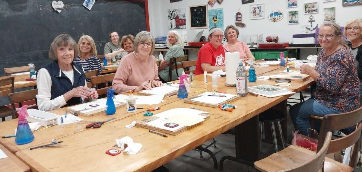 Three Arts Club members making glass ornaments at Mudsock Glass in Edon