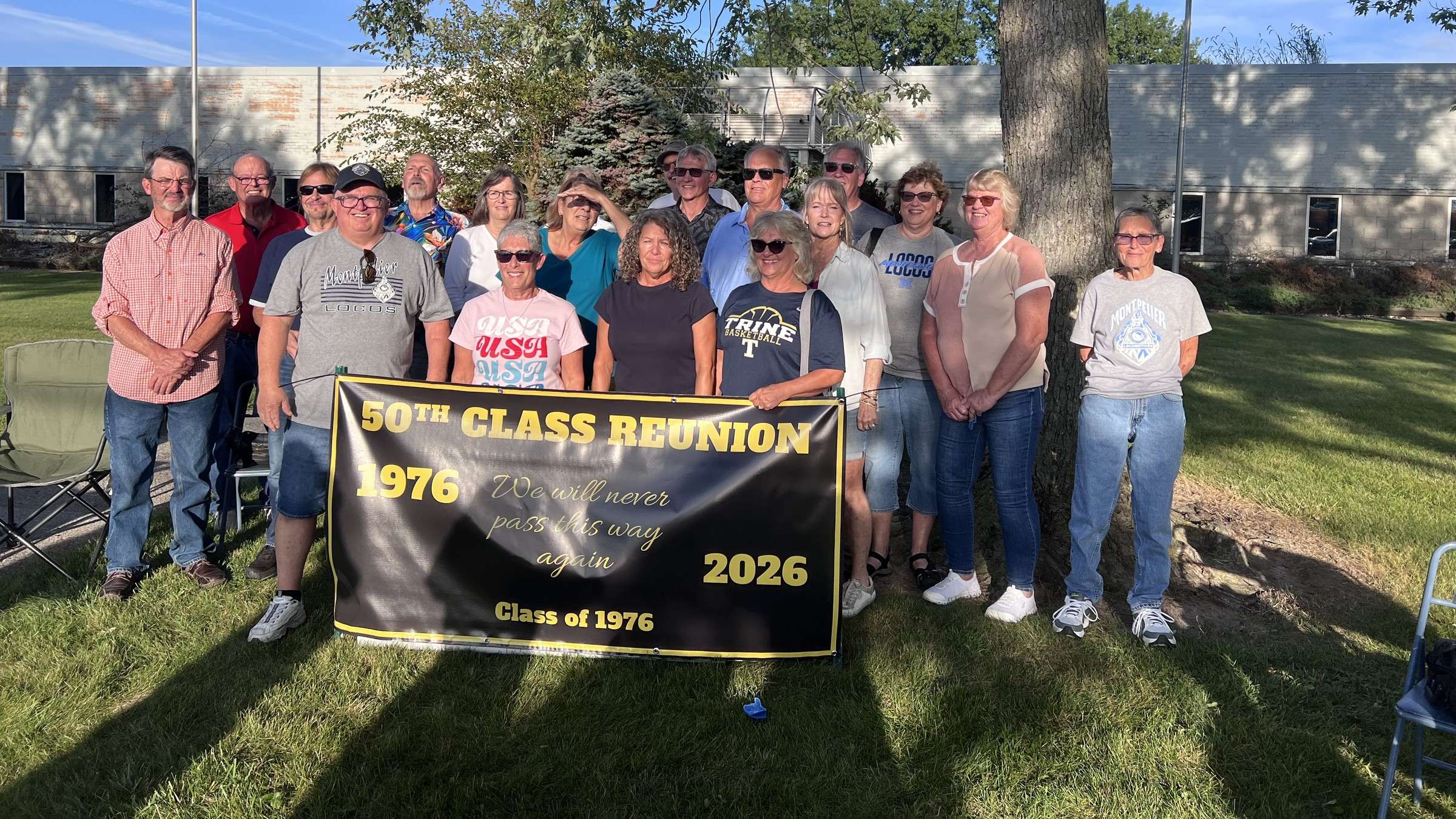 Members of the Montpelier Class of 1976 pose with a 50th Class Reunion banner