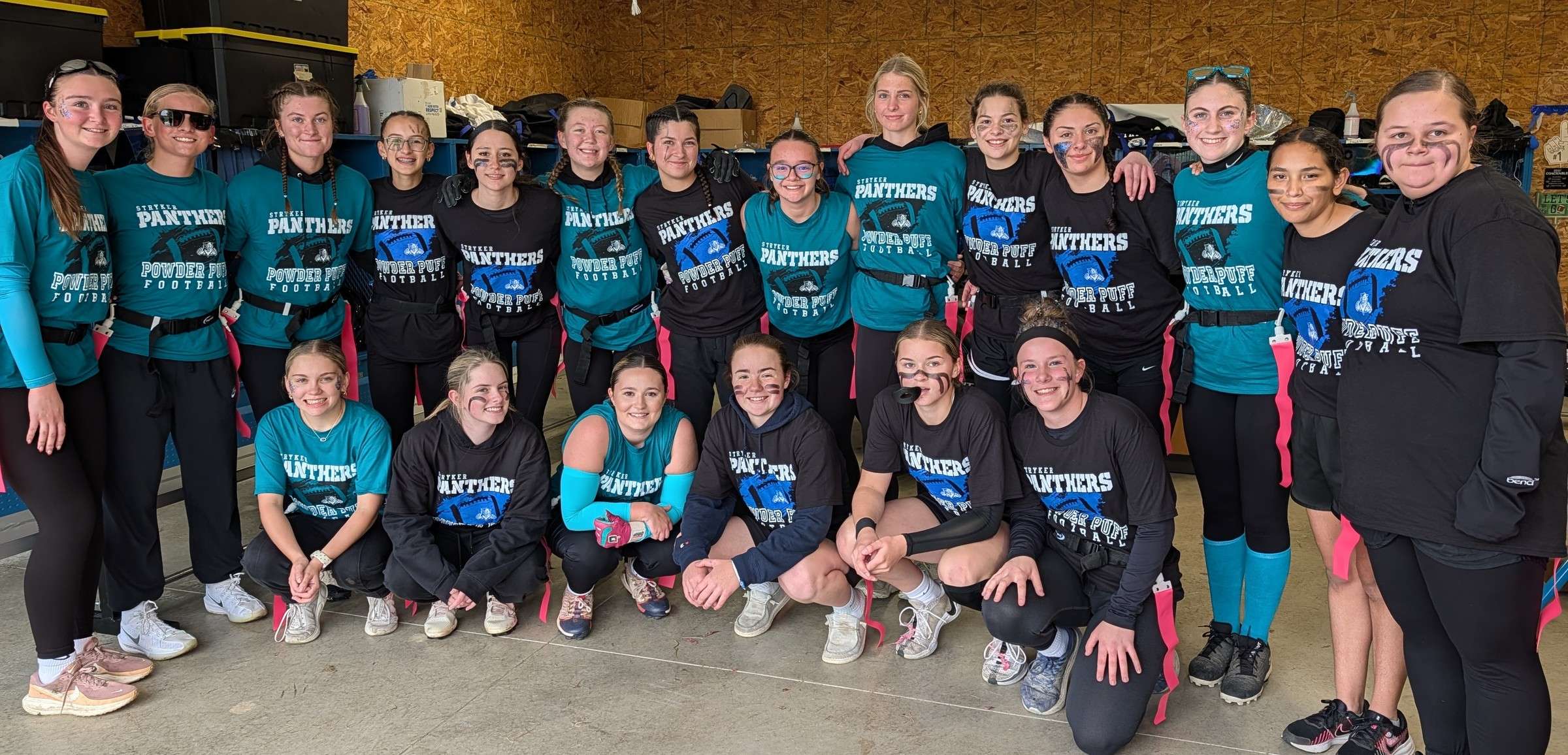 Members of the Stryker Big Puffs and Under Dogs Powder Puff football teams pose together