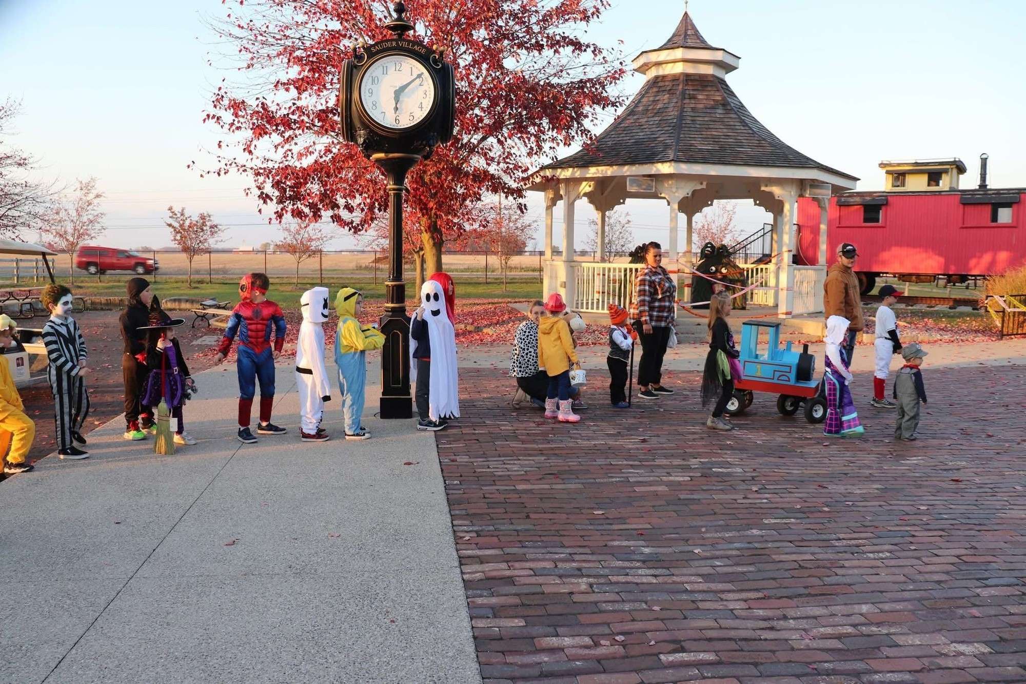 Children in Halloween costumes line up to trick-or-treat at Sauder Village