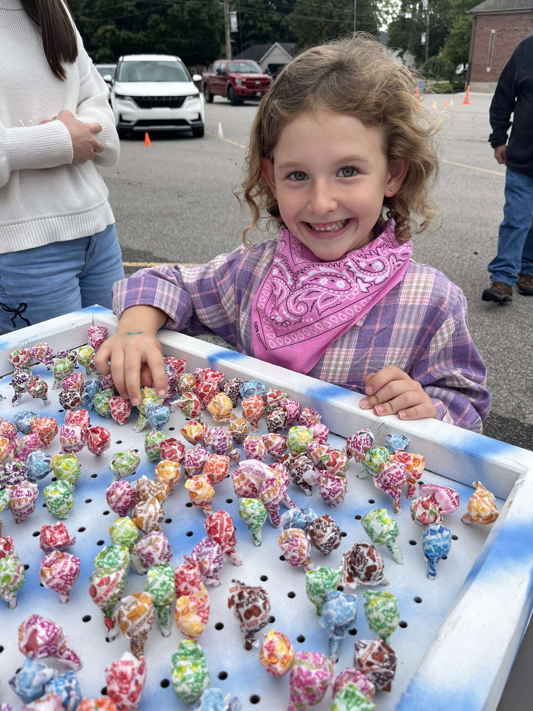 St. Mary School Grandparent Day carnival: a girl in a bandana at the lollipop game