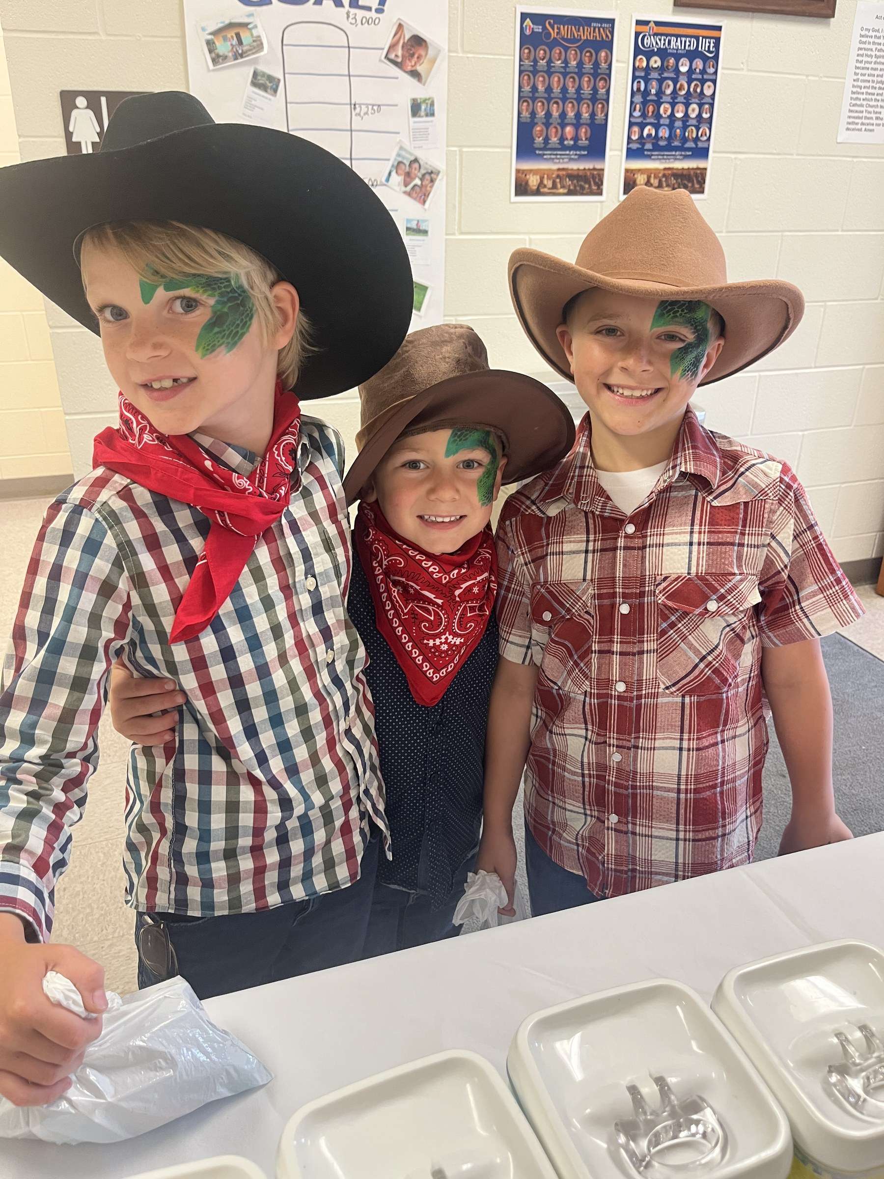 St. Mary School Grandparent Day carnival: three children in cowboy hats and bandanas