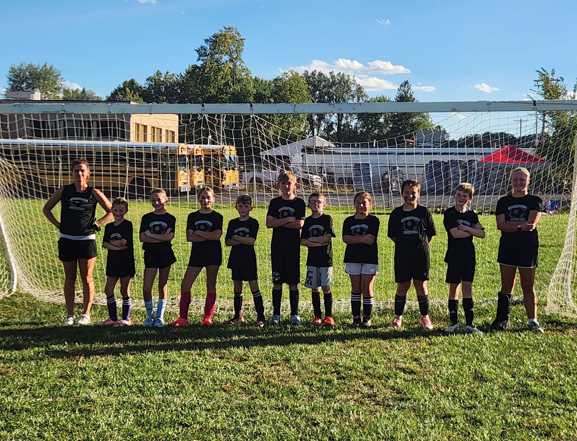 Swanton 10U Black soccer team in front of a goal
