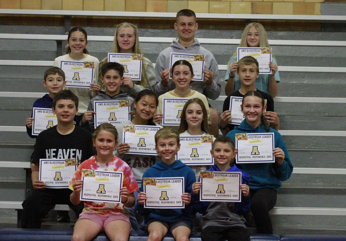 Archbold Middle School October Bluestreak Leaders hold their certificates on the gym bleachers