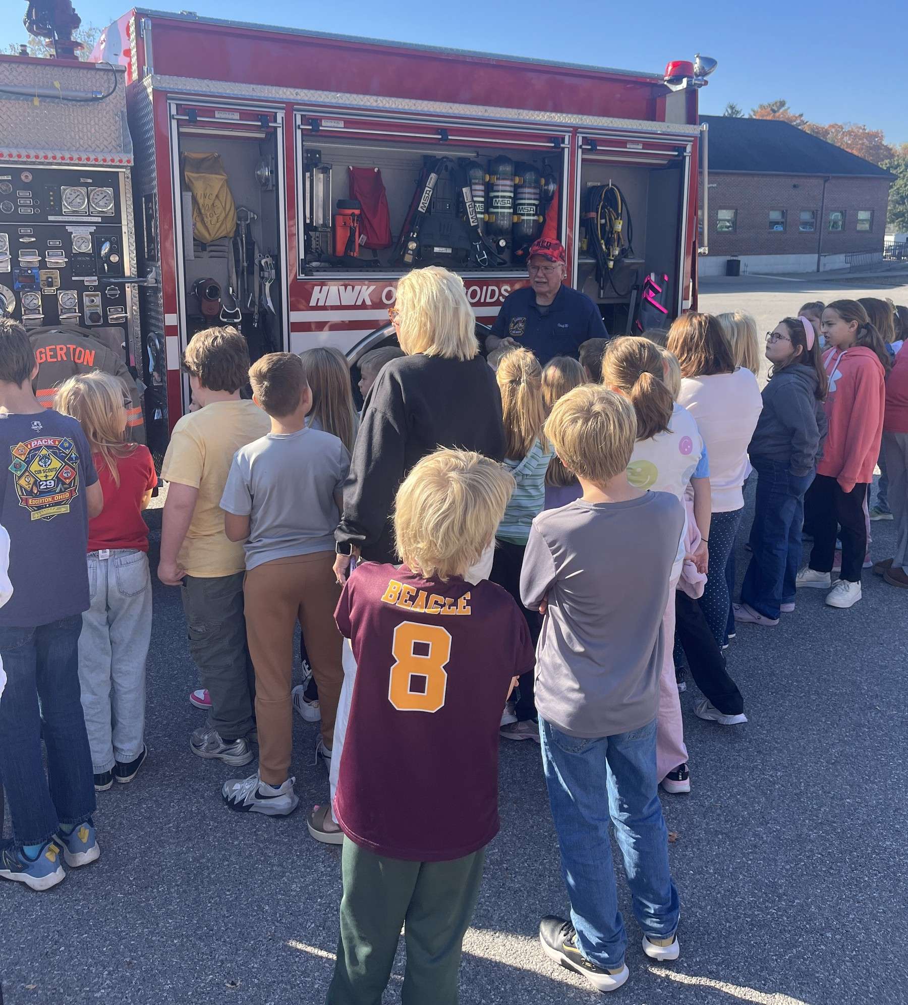 Students look at equipment stored in an Edgerton fire truck