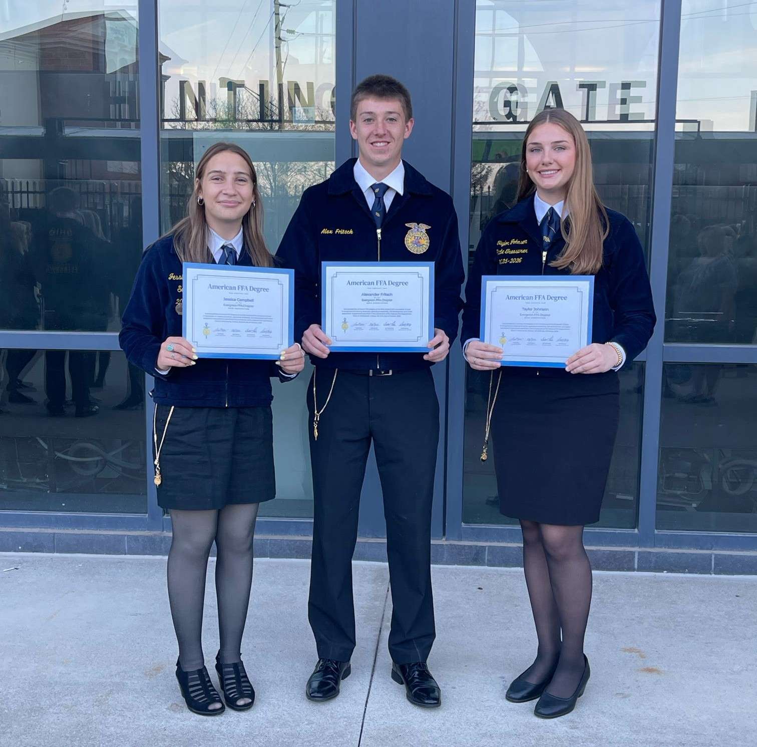 Three Evergreen FFA graduates holding their American FFA Degree certificates