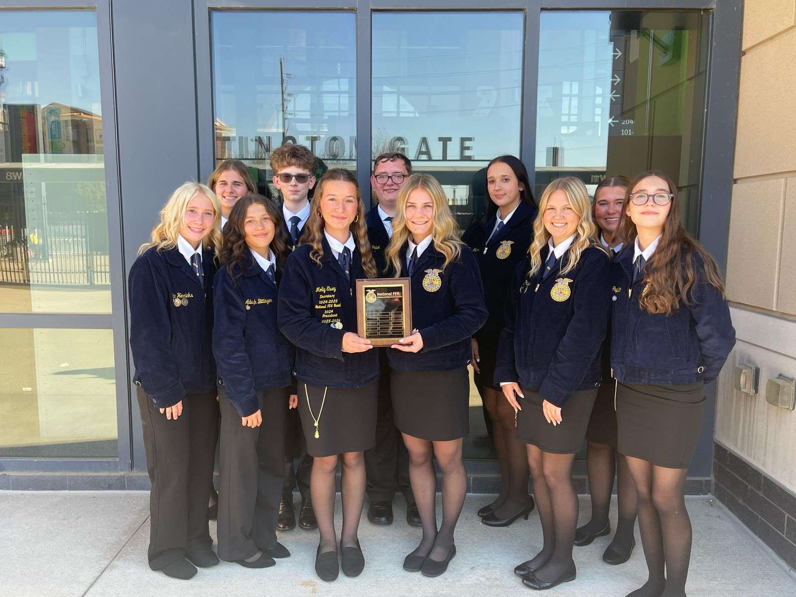 Evergreen FFA members holding the two-star chapter national award plaque